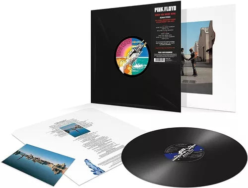 Vinilo remasterizado 1 LP 180 g de Wish You Were Here con funda interior impresa y postal de Pink Floyd desplegados sobre superficie neutra.